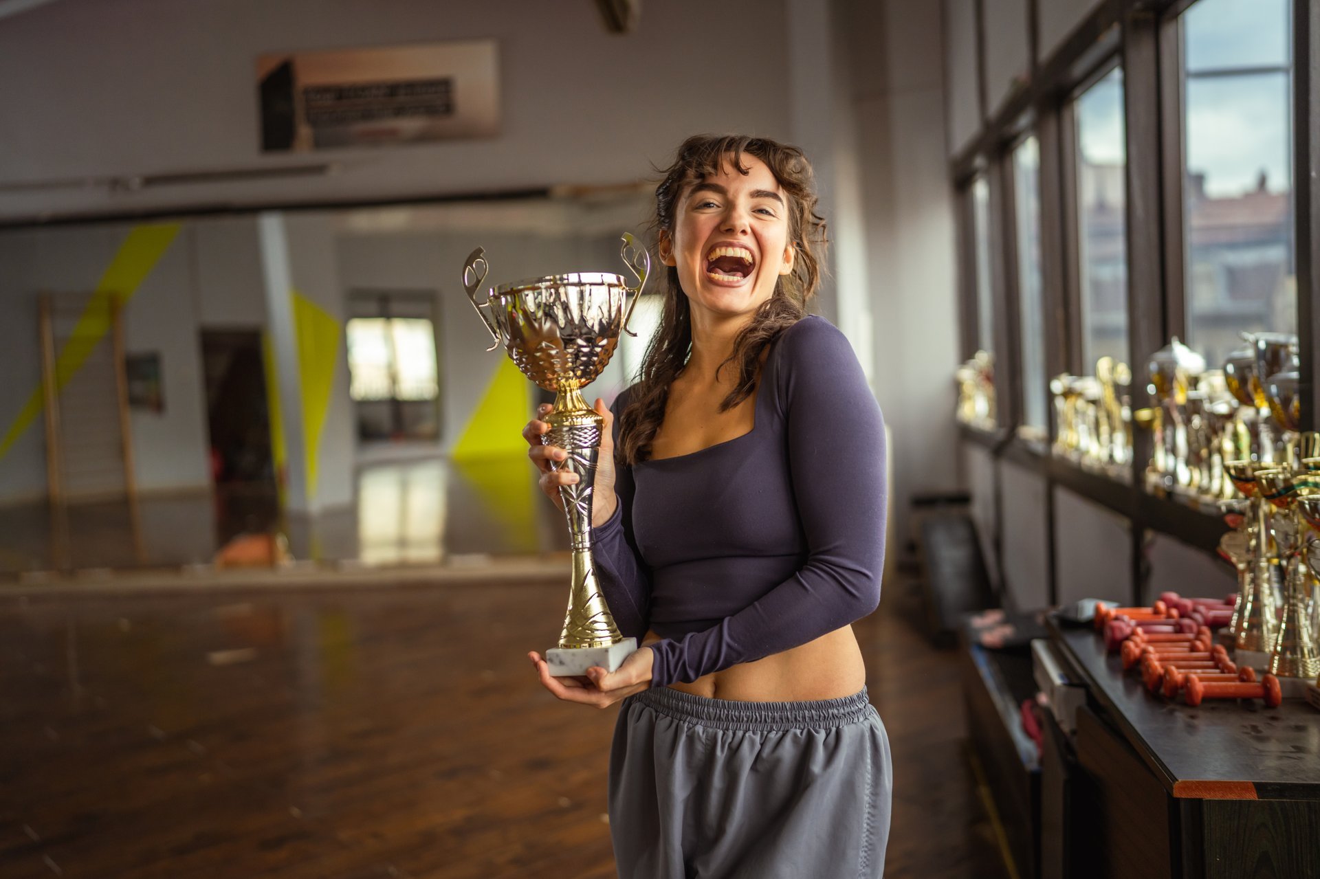 Woman holding golden trophy celebrating victory